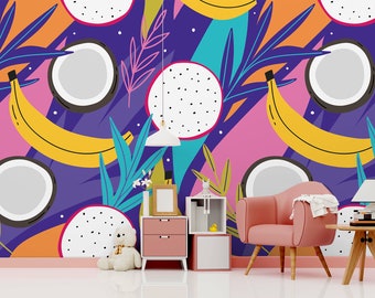 May include: A colourful wall mural with a tropical theme featuring bananas, coconuts, and dragon fruit. The mural is in a room with a pink armchair, a side table, and a lamp.