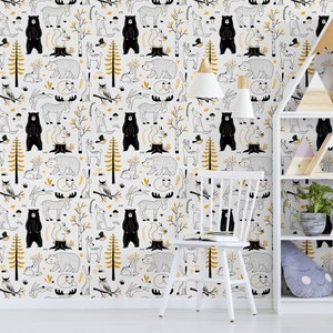 May include: A white wall with a black and gold woodland animal print wallpaper. A white chair and a white bookshelf with wooden shelves and triangular wooden decorations are in front of the wall.