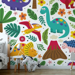 May include: A white wall mural with a colorful dinosaur theme. The mural features dinosaurs, palm trees, flowers, and a volcano. The mural is perfect for a child's bedroom.