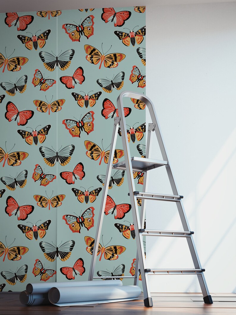 May include: A roll of wallpaper with a repeating pattern of colorful butterflies on a light blue background. A silver step ladder is in the foreground.