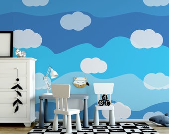 Puede incluir: Una habitación infantil con papel pintado de cielo azul y nubes. Una cómoda blanca, un escritorio gris pequeño con una lámpara blanca y dos sillas blancas están frente a la pared. Una alfombra a cuadros blancos y negros está en el suelo.