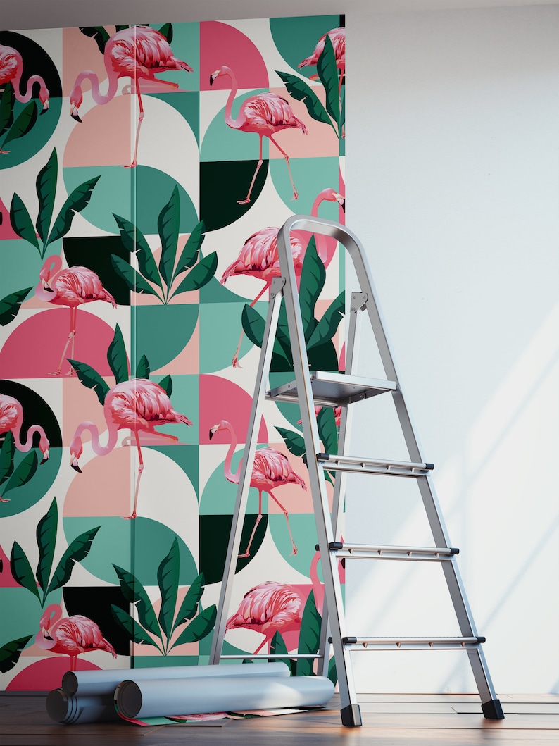 May include: Pink flamingos and tropical leaves on a geometric pattern wallpaper. The wallpaper is being installed on a white wall with a silver step ladder.