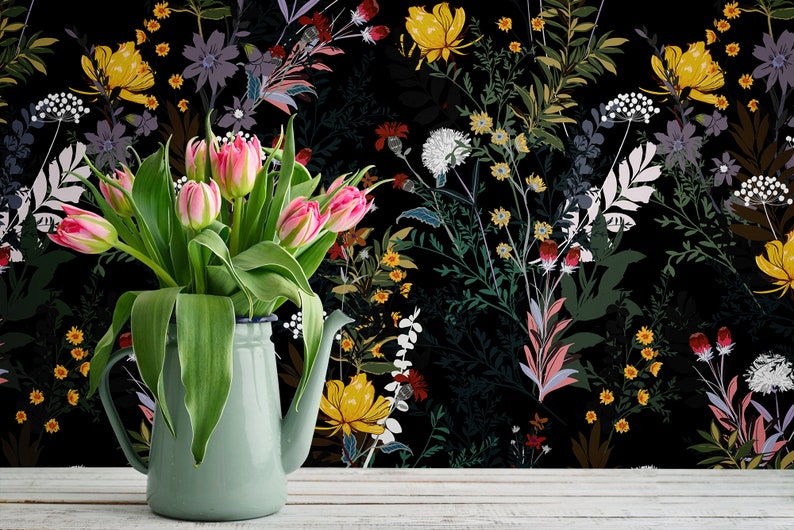 May include: A bouquet of pink tulips in a light green pitcher against a black background with a floral pattern. The flowers are arranged in a vase with a white rim.