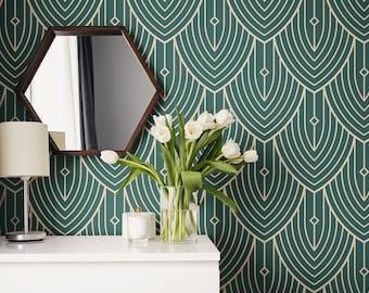 May include: A room interior featuring a white dresser, a dark wood hexagonal mirror, and a green patterned wallpaper. A vase of white tulips sits on the dresser, next to a small lamp and a candle. The wallpaper has a repeating art deco design.