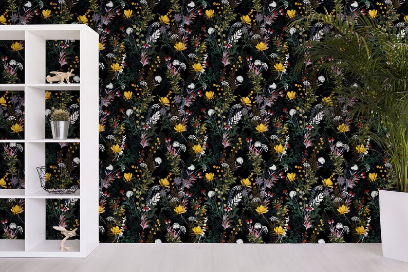 May include: Black wallpaper with a floral pattern featuring yellow, white, red, and green flowers. The wallpaper is shown in a room with a white shelf unit and a potted plant.