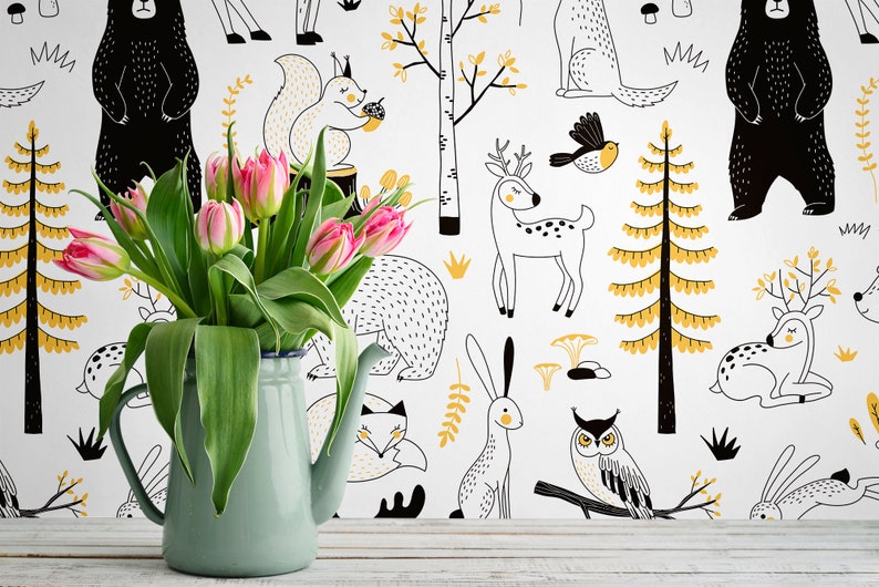 May include: A white background with black and yellow illustrations of woodland animals, including bears, deer, squirrels, owls, and rabbits. A bouquet of pink tulips is in a light blue pitcher in the foreground.