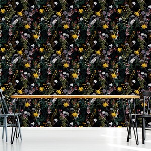May include: A black and white floral wallpaper with a repeating pattern of yellow, red, and white flowers. The wallpaper is shown in a dining room setting with a wooden table and two black chairs.