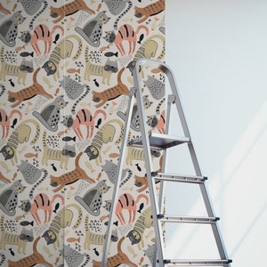 May include: A white background with a repeating pattern of colorful cats, fish, and abstract shapes. The cats are in various poses, including sitting, standing, and sleeping. The fish are in different colors and sizes. The abstract shapes are in various colors and patterns.