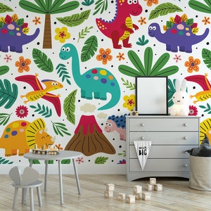 May include: A colorful dinosaur themed wallpaper mural with a variety of dinosaurs, including a triceratops, stegosaurus, pterodactyl, and a volcano. The mural is in a child's room with a small table and chairs, a dresser, and a toy basket.