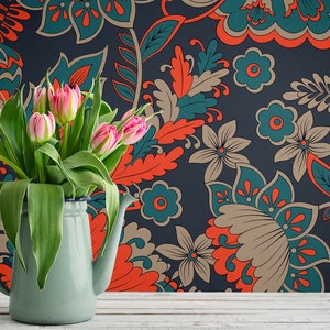 May include: A bouquet of pink tulips in a light blue enamel pitcher against a dark blue background with a floral pattern in shades of teal, orange, and brown.