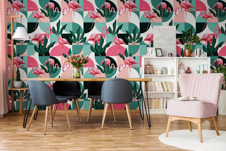 May include: A dining room with a pink and green geometric wallpaper featuring pink flamingos. The wallpaper has a modern design with circles and squares. There is a wooden table with four black chairs and a pink armchair in the room.