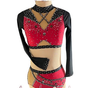 May include: A red and black dance costume with long sleeves and a high neckline. The costume features a mesh midriff and is embellished with rhinestones. The words "burgundy blush" are written in cursive script.