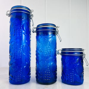 Vintage Cobalt Blue Glass Jars, set of three, with wire closure, embossed fruits, for pantry storage, country farmhouse kitchen, home decor