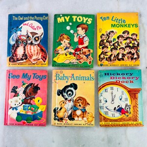 May include: Six vintage children's books are displayed, including "The Owl and the Pussy Cat," "My Toys," and "Ten Little Monkeys." The books have colourful illustrations and are part of the Rand McNally Junior Elf Book series. The books are in good condition.