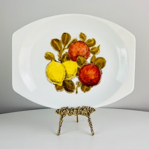 May include: White oval serving platter with a painted design of lemons and oranges in shades of yellow, orange, and green.