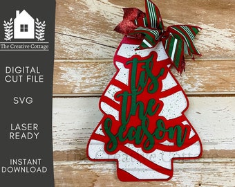 May include: Red and white striped Christmas tree cutout with the words "Tis the Season" in green lettering.