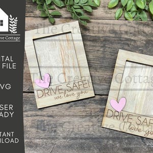 May include: Two wooden picture frames with a light brown finish. Each frame has a cutout heart shape and the text "DRIVE SAFE! We love you".