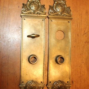 May include: A handmade wooden sign with the text "Welcome to our home" in a handwritten style. The sign is painted white with black lettering and a distressed finish. A small, decorative heart is on the bottom.