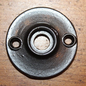 May include: Black metal door knob backplate with two screw holes.