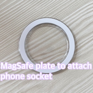 以下が含まれることがあります： 電話ソケットを取り付けるための白い接着剤付きMagSafeプレート