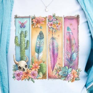 May include: A white t-shirt with a colorful graphic design featuring a skull, cactus, butterflies, and feathers. The design is framed with a floral border.