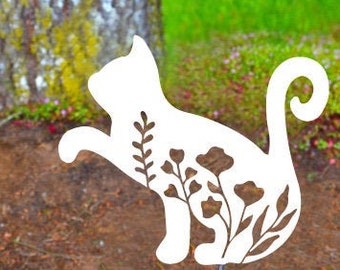 May include: A white metal garden stake shaped like a sitting cat with a curled tail. The silhouette of the cat features cut-out designs of various floral stems and leaves throughout its body, mounted on a thin metal rod for ground placement.