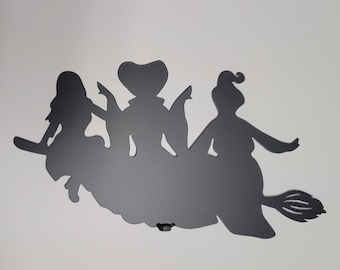 Three witches on a broom – metal Halloween wall art & yard décor. Handmade witch trio silhouette, spooky and durable seasonal decoration.