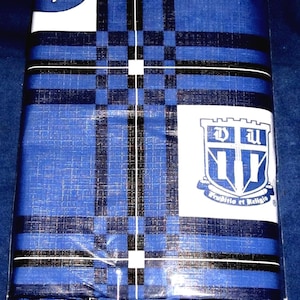 May include: A blue and white plaid fabric with a Duke University logo in the center. The logo is a shield with a cross and the letters "DU" above the cross and "11" below the cross. The text "Providentia et Religio" is below the shield.