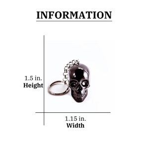 May include: Black skull keychain with a silver chain and ring. The skull is 1.5 inches tall and 1.15 inches wide.