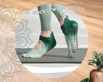 May include: Green toe socks with grips. The socks have a gradient color design, transitioning from a lighter green at the toes to a darker green at the ankle. The soles feature non-slip grips. The text "Toe socks with grips" is visible.