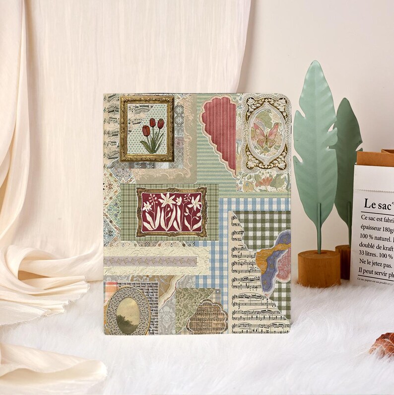 May include: A decorative journal cover with a collage of vintage images and patterns. The design includes framed floral art, a butterfly, musical notes, and a gingham pattern. The colour palette is soft, with greens, reds, and creams.