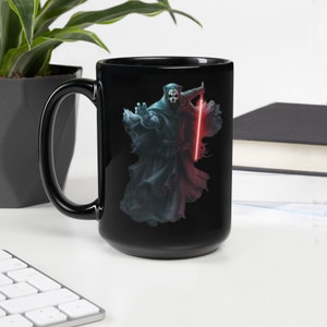 May include: Black ceramic mug featuring a dark figure wielding a red lightsaber. The figure is wearing a dark hooded robe and has a mask.