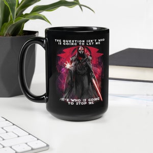 May include: Black ceramic mug featuring a red and black illustration of a character from Star Wars. The text on the mug reads "The question isn't who is going to let me. It's who is going to stop me."
