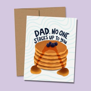 May include: A greeting card with a stack of pancakes topped with blueberries and syrup. The card reads "Dad, no one stacks up to you".