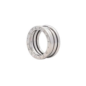 May include: A silver Bvlgari B.zero1 ring with three bands. The bands are engraved with the Bvlgari logo.