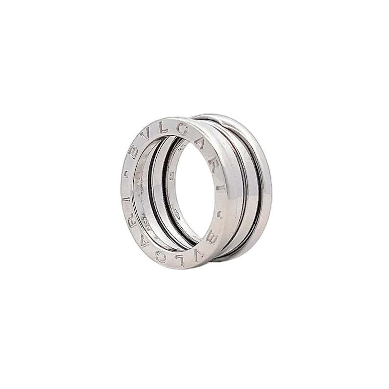 May include: A silver Bvlgari B.zero1 ring with three bands. The bands are engraved with the Bvlgari logo.