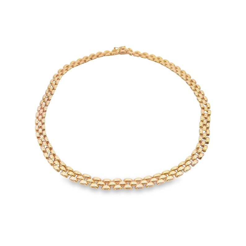 May include: A gold chain necklace with a delicate, interlocking pattern. The chain is made of multiple strands of small, rounded links.