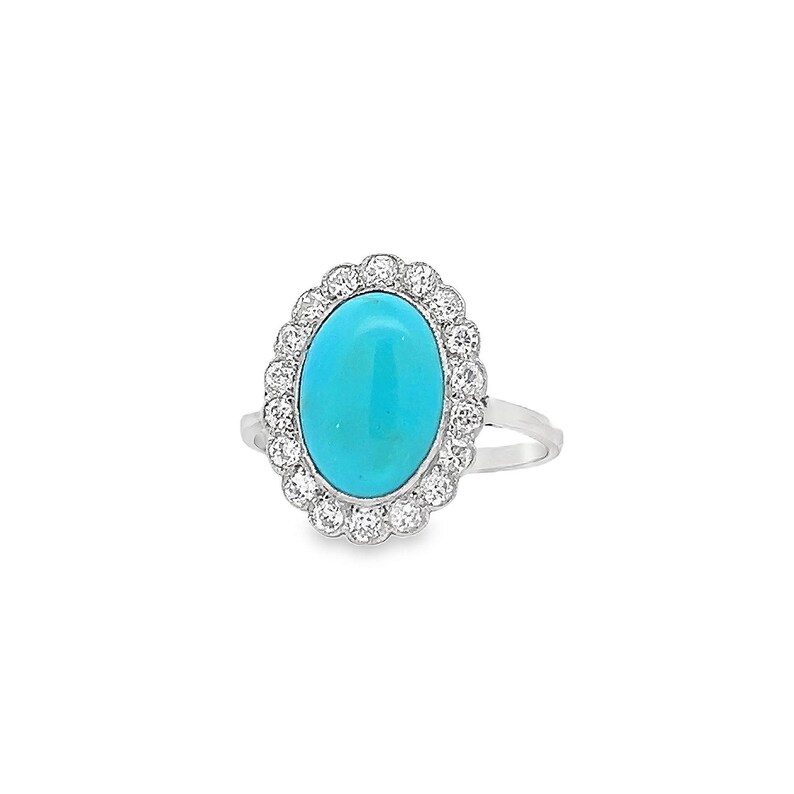 May include: A silver ring featuring a turquoise oval gemstone set within a halo of small diamonds.