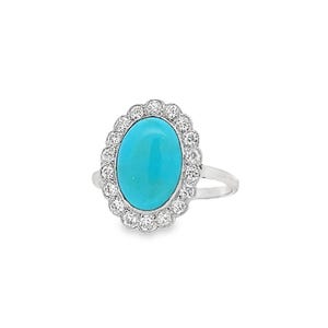 May include: A silver ring featuring a turquoise oval gemstone set within a halo of small diamonds.