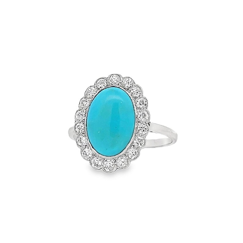 May include: A silver ring featuring a turquoise oval gemstone set within a halo of small diamonds.