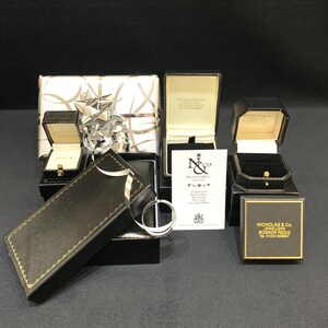 May include: Four black gift boxes with gold trim and a white gift box with a silver bow. The boxes are labeled "Nicholas & Co. Jewellers Bognor Regis".