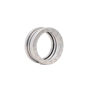 May include: A silver ring with the words "BVLGARI" engraved around the band.