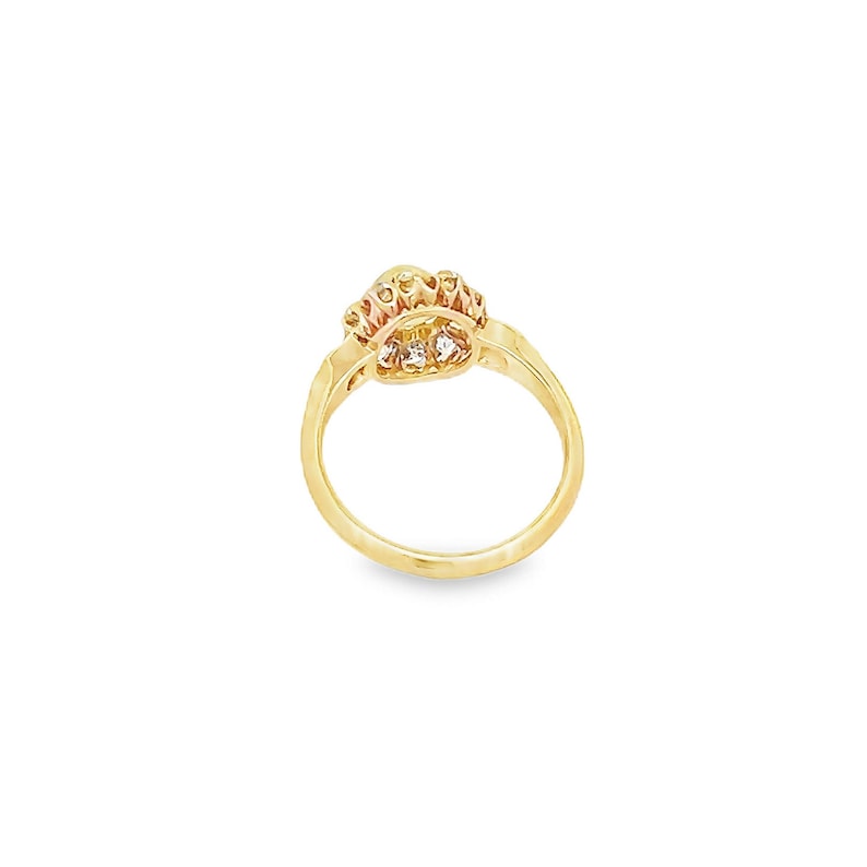 May include: A gold ring with a heart-shaped design and a row of small clear stones around the edge.