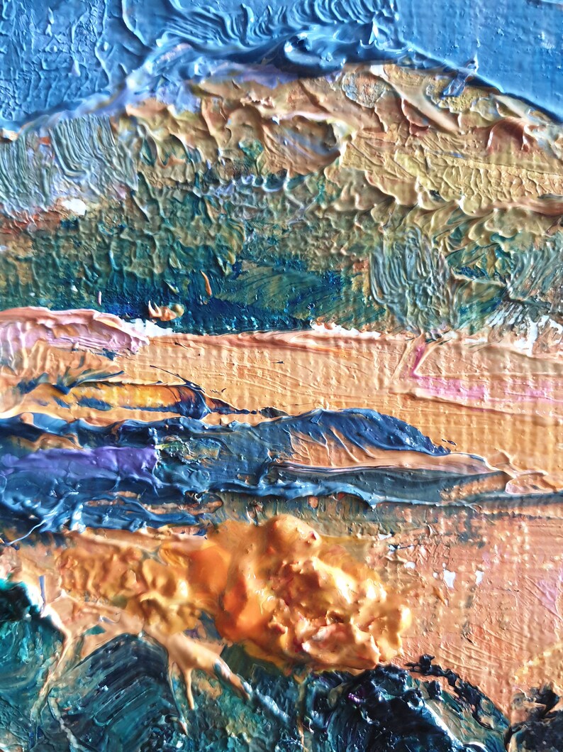 May include: Abstract painting with thick layers of blue, green, orange, and yellow paint. The paint is applied in a textured, impasto style, creating a sense of depth and movement.