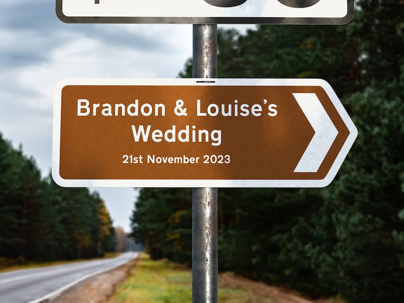 May include: A brown directional sign with a white arrow pointing to the right. The sign reads "Brandon & Louise's Wedding 21st November 2023".