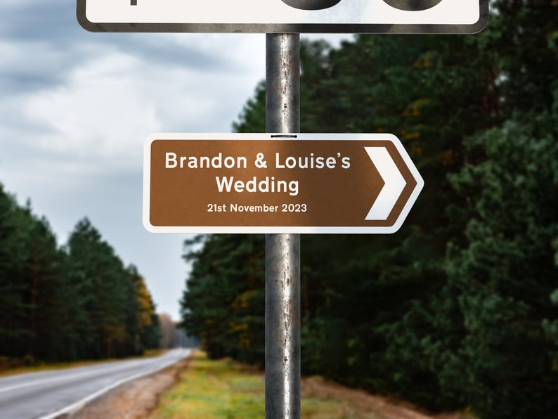 May include: A brown and white directional sign with a white arrow pointing to the right. The sign reads "Brandon & Louise's Wedding 21st November 2023".