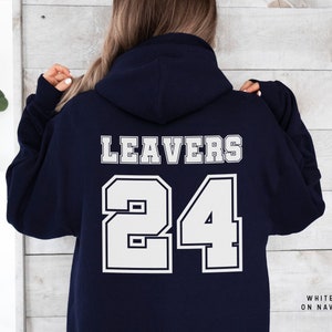 May include: Navy blue hoodie with white text that says "Leavers 24" on the back. The text is in a sporty font.
