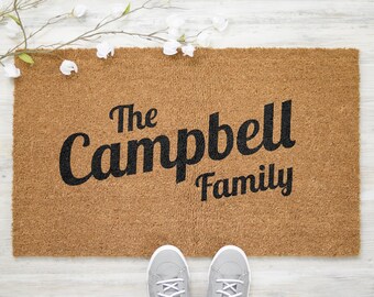 May include: A brown coir doormat with the text "The Campbell Family" in black lettering.