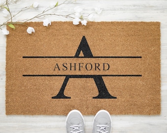 May include: A brown coir doormat with the letter "A" and the name "ASHFORD" in black lettering.