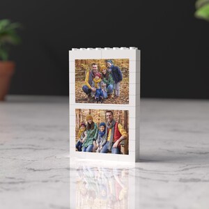 May include: A white photo block with two pictures of a family in a wooded area. The top picture shows a family of five standing in the woods. The bottom picture shows a family of six sitting on a log in the woods.